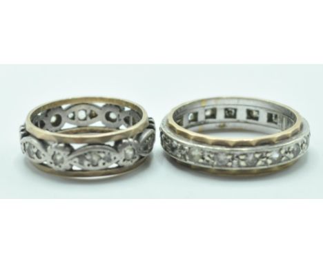 A hallmarked 9ct gold two tone eternity ring being set with round cut white stones. (Hallmarked London 1988, size O, weight 4