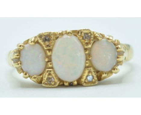 A 18ct gold and opal ring. The ring having large opal stone of an oval form to the centre flanked by two smaller opal stones 