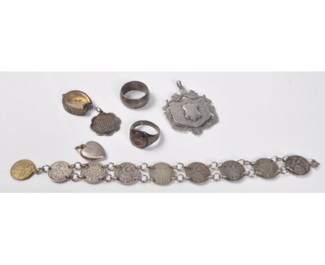 A collection of 20th century stamped silver jewellery to include an enamelled ring with the a Cornish crescent, a silver band