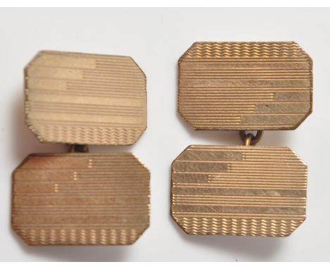 A pair of 9ct gold&nbsp;cufflinks of a rectangular form with engine turned decoration to the front. Stamped 9ct gold back &am