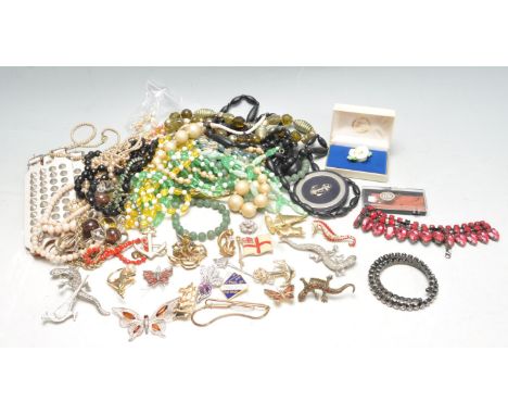 A collection of vintage retro 20th century ladies costume jewellery to include beaded necklaces, brooches, bangles, enamel br