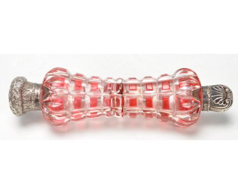 A 19th Century Victorian silver and flash glass double ended scent bottle having a faceted ruby glass body with silver repous