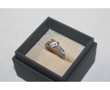 A costume ring set with white stones 