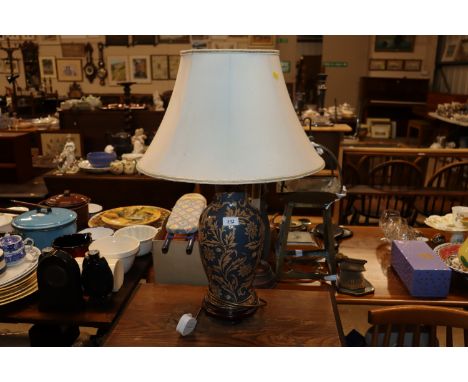 A floral decorated baluster table lamp and shade