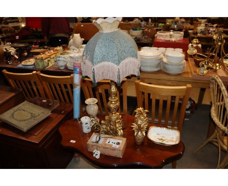 A gilt table lamp and shade; pineapple ornaments; pottery feet in the form of hares etc