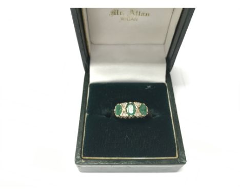 A 9ct yellow gold emerald and diamond ring. Size approx R, weight approx 3g.