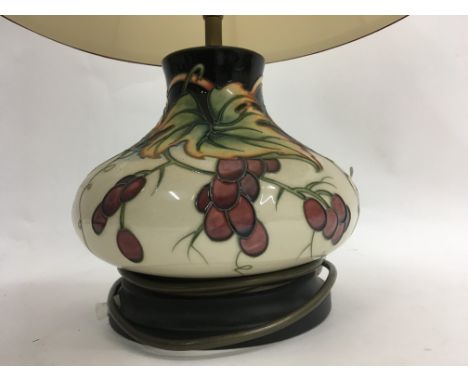 A morcroft table lamp with shade decated with leafs and berrys