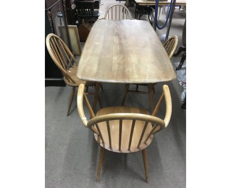 An Ercol lightwood dining table and four chairs including two carvers, in need of restoration.Approx 72x1.45x72cm