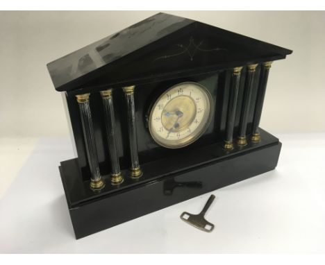 A black slate mantle clock with Corinthian column supports and a 1930's oak cased mantle clock with silvered dial (2).