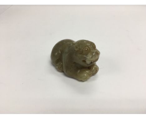 A jade type dog, approx length 6.5cm and approx height 4cm.