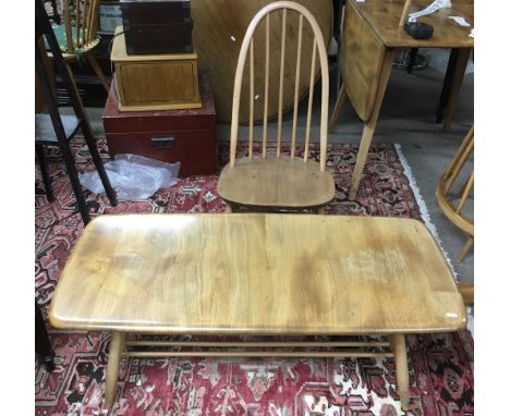 An Ercol light elm coffee table with magazine rack and conforming low, high back chair.Approx 1.3m long