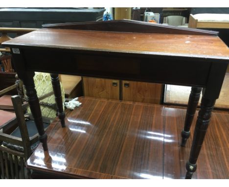 A Victorian mahogany side table the rectangular top above a single drawer on turned legs