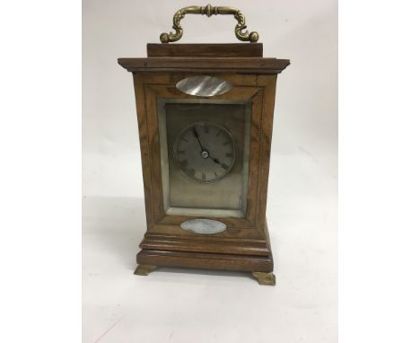 A French walnut case clock inset with mother of pearl the silvered dial with Roman numerals on bracket feet the movement stri