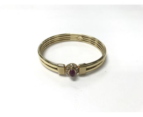 A 9ct gold ruby and diamond bangle. Weight approx 22.8g