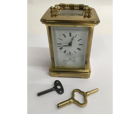 A Matthew Norman, Swiss made brass carriage clock with eleven jewel movement.
