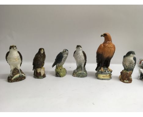 A collection of six Beswick whisky decanters in the shape of different species of bird. Three of which are filled with Beneag