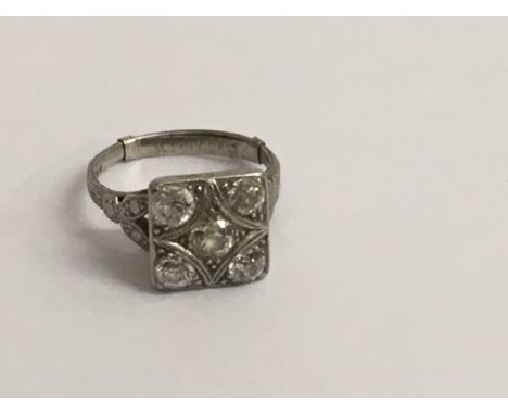 A Art Deco platinum ring inset with five diamonds size k