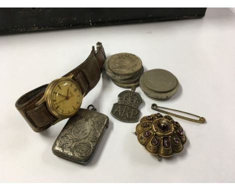 A late Victorian brooch set with amethyst cabochons and seed pearl, a silver Vesta case a Vintage Smiths Watch an ARP badge a