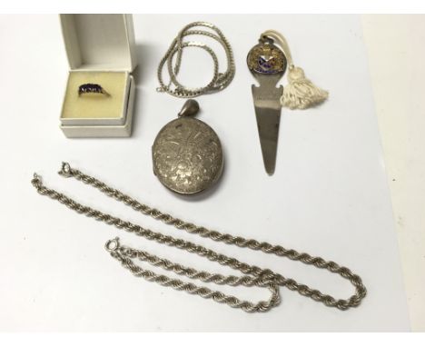 A silver rope chain and bracelet, a ring set with three stones, a oval locket with chain and a P&O book mark. Weight approx 7