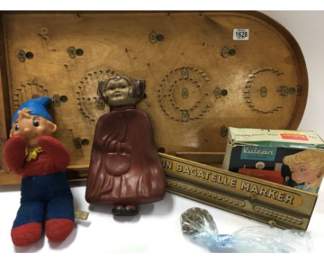 A Pin Bagatelle board with score board. A boxed toy Vulcan sewing machine a Vintage Dunlop hot water bottle and a Nody figure