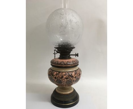 A Victorian oil lamp hinks No2 the glass shade above a pink pottery foilate font