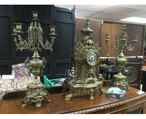 A 20th Century brass clock garniture, clock not in working condition.
