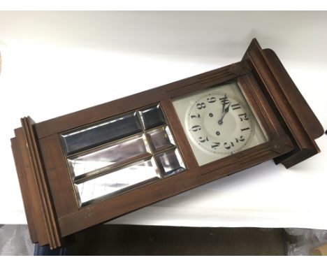 A wall clock with visible pendulum.