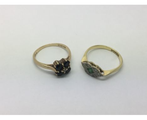 Two gold rings, one set with sapphires and approx size L and one set with a small emerald and diamond chips, approx size L - 