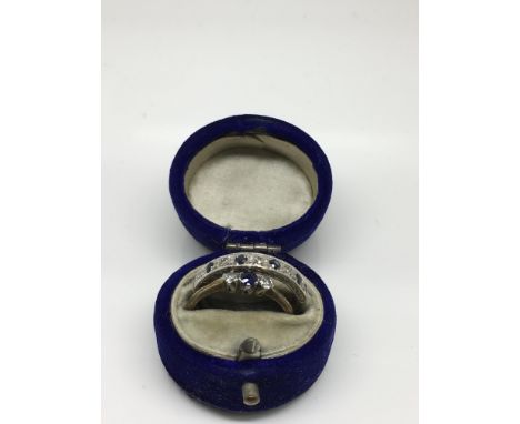 An 18ct gold and platinum sapphire and diamond engagement ring with a confirming eternity ring.Approx size M