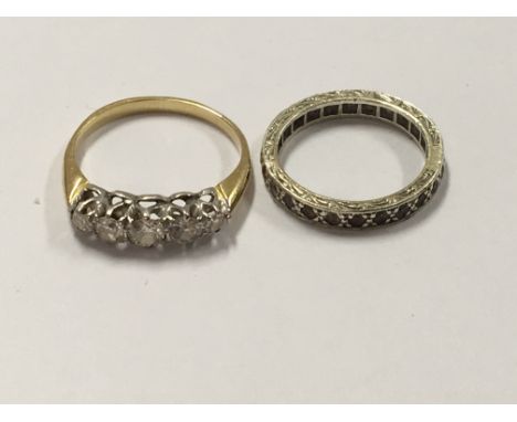 A gold ring set with a single row of five graduating old cut diamonds ring size N-M and one other eternity ring (2)