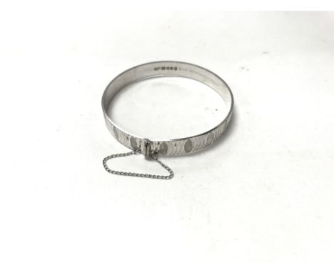 A silver bangle hallmarked M. P. B/Ham 1977 'Nymph'. Weight approx 13.6g
