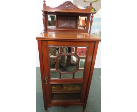 Edwardian mahogany music cabinet, the top with carved backboard, two mirror panels and shelf, the door with nine-panel mirror