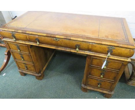 19th century pedestal desk in banded mahogany and walnut veneer, the desktop with tooled brown leather scriber, the cushion f