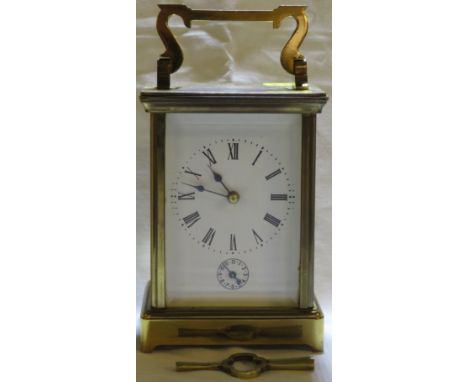A large striking carriage clock in brass corniche case, the white enamel dial with Roman chapter and subsidiary Arabic alarm 