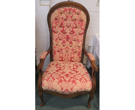 A 19th century mahogany framed balloon back armchair, recently re-upholstered to the seat, back and armrests in light red but