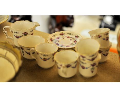 A Collingwood bone china Coffee Set decorated with trailing garlands comprising six cups and saucers, milk jug and sugar bowl