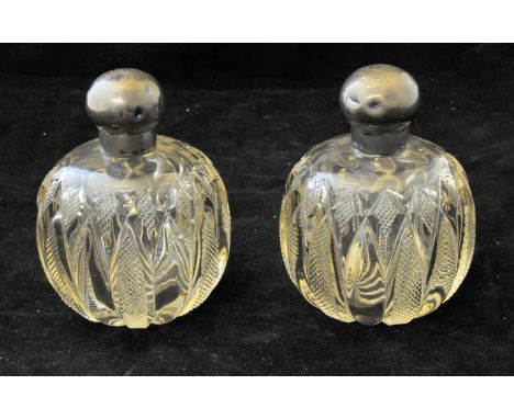 A pair of cut glass globe shape Scent Bottles with silver covers, engraved with a monogram, Chester 1897. 