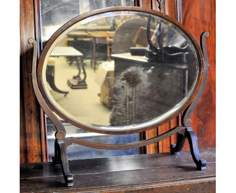An Edwardian large oval swing Toilet Mirror in line inlaid mahogany frame and skeletal stand. 