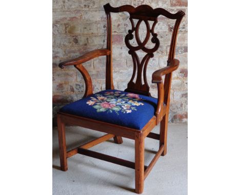 A Chippendale design fruit wood Elbow Chair with pierced splat back, serpentine cresting rail and swept scroll arms with drop