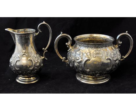 A Victorian silver two handled Sugar Bowl with embossed floral decoration, engraved with initials and inscribed 'July 5th, 18