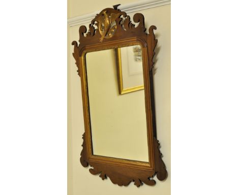 A Chippendale design upright Wall Mirror with gilt eagle pediment and gilt slip in fret carved mahogany frame. 2' 7 1/2" (80c