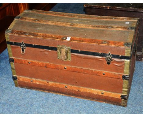 A vintage wood bound travel trunk, of dome shape, with hinged lid and two metal carry handles, 48cm high x 90cm wide