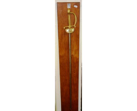 A Wilkinson Cavalry style sword, with gilt metal pommel and hilt, metal etched blade, raised on an oak wall mount, 96cm long
