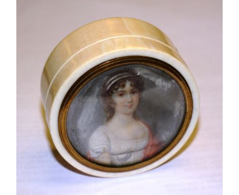 A late 19th century French circular turned ivory box, the cover inset with painted portrait of a lady in 17th century dress, 