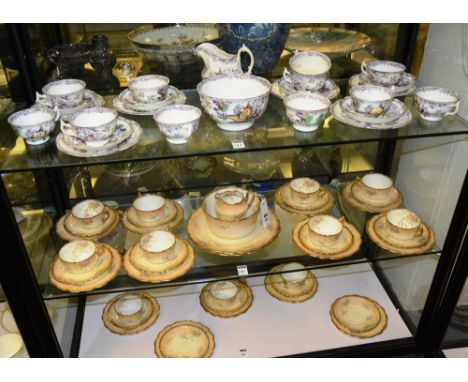 A floral decorated china teaset, comprising of two biscuit plates, 13 side plates, 13 saucers, 11 cups, cream and sugar, with