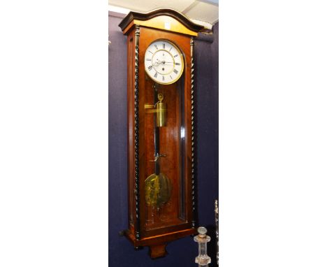 A Vienna single weight regulator wall clock, cased in walnut and ebonised spiral twist column supports, with glazed door encl
