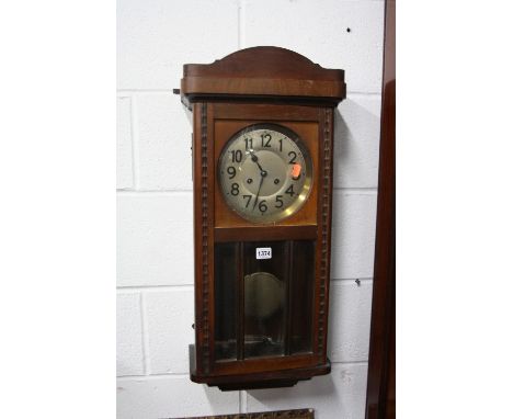AN OAK CASED WALL CLOCK (key and pendulum)