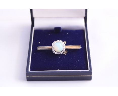 AN OPAL AND DIAMOND BROOCH, with cushion shaped opal within a surround of old cut diamonds to a plain bar brooch, estimated t