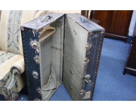A DARK BLUE METAL BOUND WARDROBE TRAVELLING TRUNK, with fitted interior initialled 'S Watajoy, London, maker's label attached
