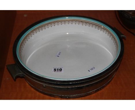 A TWIN HANDLED WOODEN DISH, with silver plated mounts and a ceramic liner